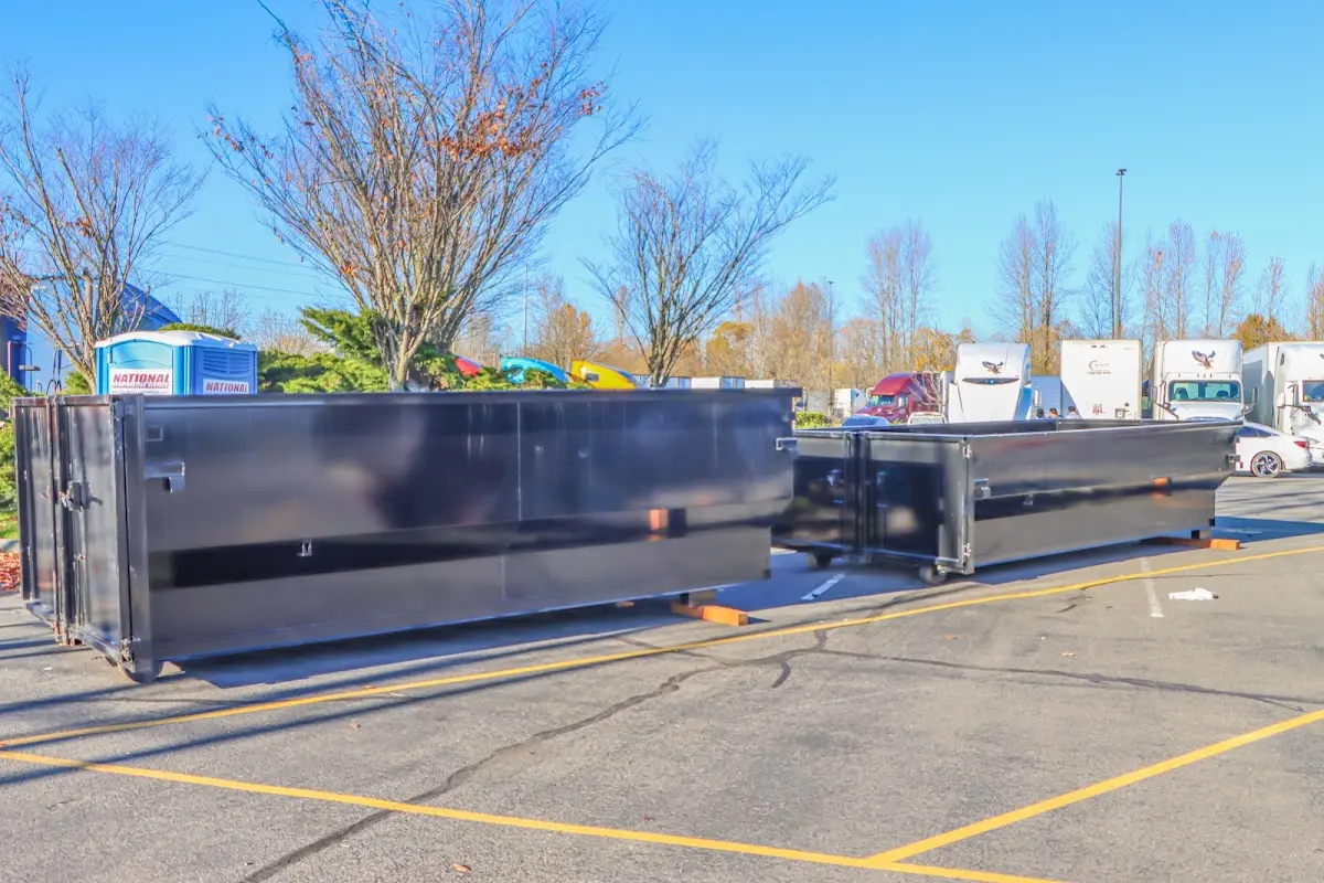 Professional dumpster rental service with roll-off container on residential driveway in Fontana